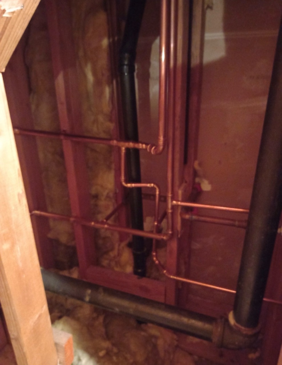 Copper plumbing lines installed inside an open wall cavity